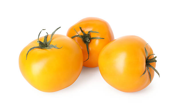 istock Many ripe yellow tomatoes isolated on white 2239820047