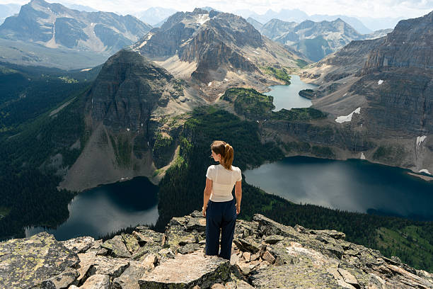 istock Hiker overlooking scenic mountain range with lakes 2239825380