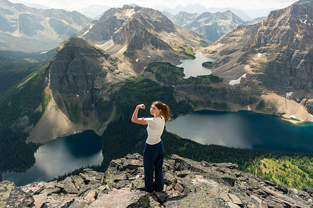 istock Triumphant hiker flexing in the mountains, lakes and peaks 2239825450