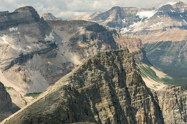 Mountainous Terrain: A vast landscape of peaks and valleys under a cloudy sky