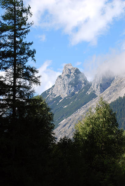 istock Alpine Mountain Peak Above Forest Silhouette 2239826408