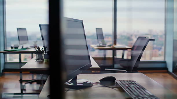istock Modern coworking workspace computers wooden desks closeup. Empty bright office 2239826838