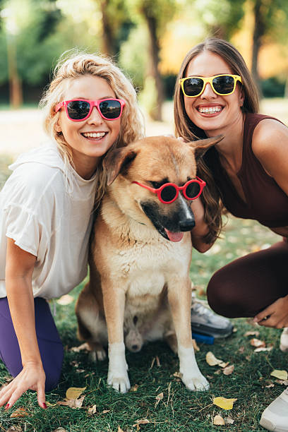 istock Best friends having fun with their cool dog 2239827538