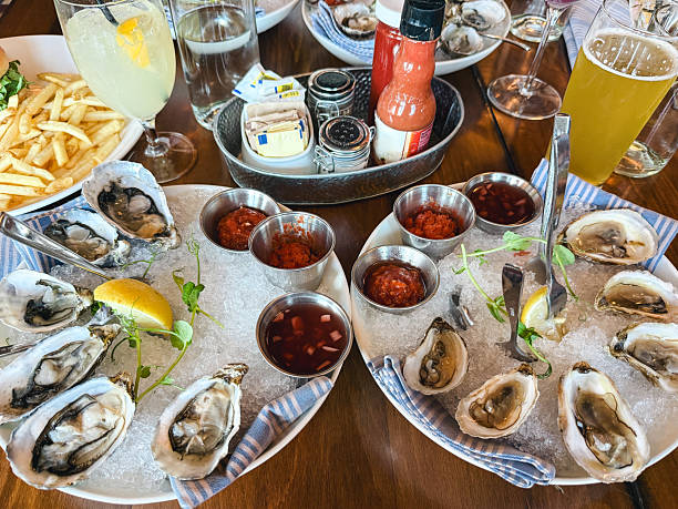 istock Fresh raw oysters on ice with sauces and lemon 2239828776