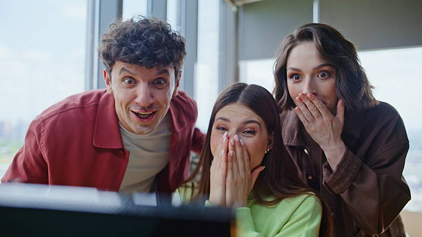 istock Three winners looking computer office closeup. Coworkers rejoicing achievement 2239829026