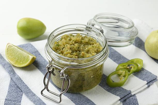 istock Delicious salsa sauce in jar and products on white table, closeup 2239829754