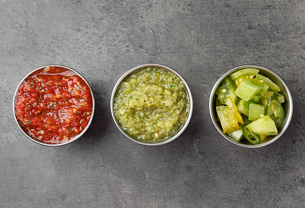 istock Different types of salsa in bowls on grey textured table, flat lay 2239829799