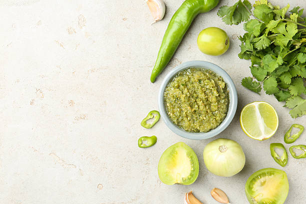 istock Delicious salsa sauce in bowl and ingredients on light textured table, flat lay. Space for text 2239829879