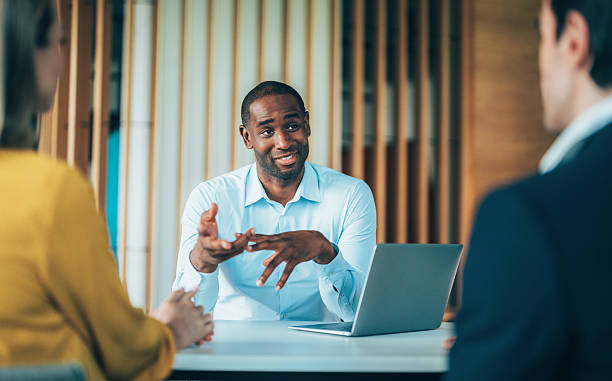 istock Confident team leader leading a discussion in a modern office 2239830447