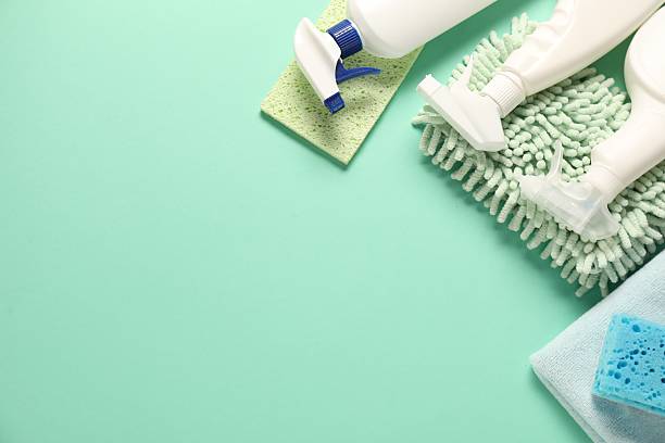 istock Different cleaning products and tools on turquoise background, flat lay. Space for text 2239830586
