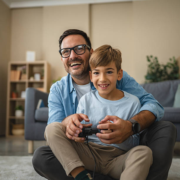 istock Father and son bonding playing video games at home 2239830701
