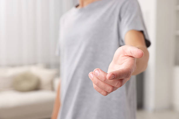 istock Offering help. Man reaching his hand indoors, closeup 2239831926