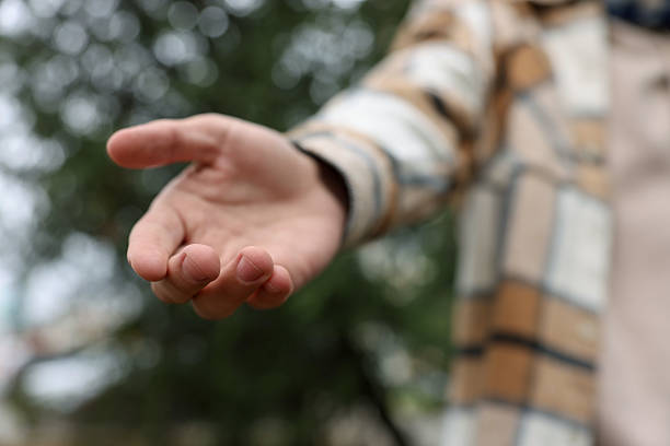 istock Offering help. Man reaching his hand outdoors, closeup 2239831930