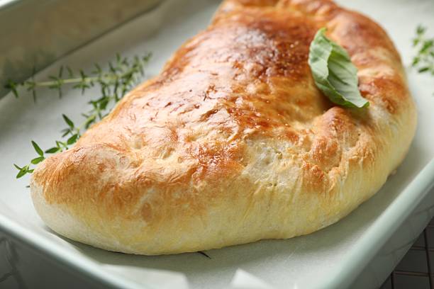 istock Delicious calzone pizza in baking dish, closeup 2239833352