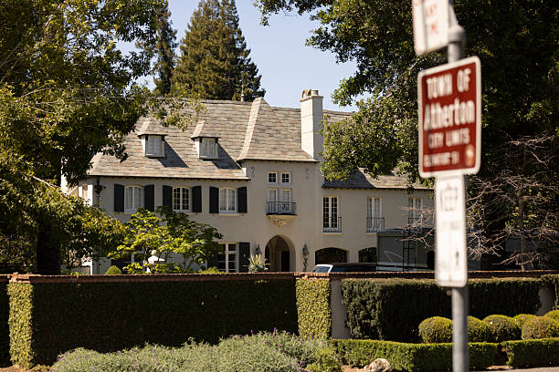 Los Angeles, CA - November 16, 2025: A house with a beautiful tree out front in Beverly Hills.