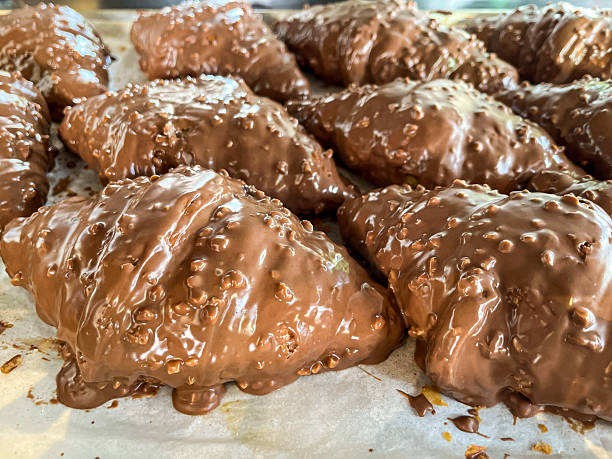 istock Chocolate covered croissants close-up  crispy texture and glossy coating 2239838116