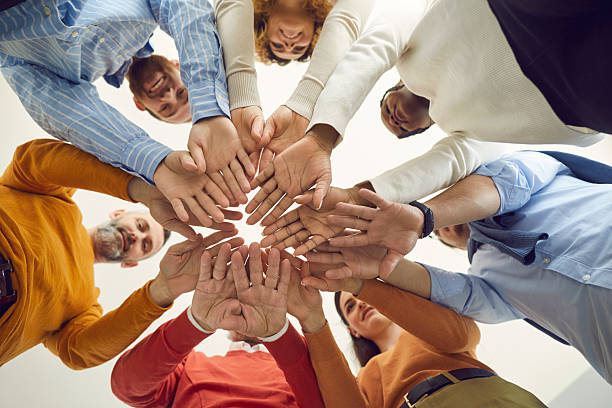 istock Diverse multiethnic people group holding hands together view from bottom 2239838460