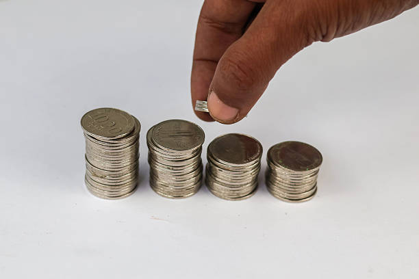 istock Close up hand compile Silver coins stacked 2239840454