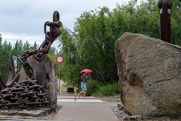 Barcelona, Spain - July 27, 2023: A view of Placa del Mar square in La Barceloneta, Barcelona, Spain, highlighting the Homenatge a la Natacio sculpture, tribute to swimming as sport, in the foreground