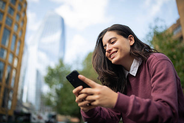 istock Texting with my friends while relaxing outdoors. 2239843494