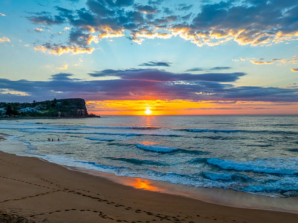 istock Seaside Sunrise Under a Cloud-Filled Sky 2239844456
