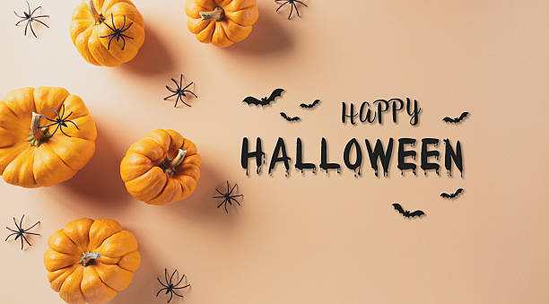 istock Halloween decorations made from pumpkin and black spider on pastel orange background. Flat lay, top view with copy space for text. 2239847199