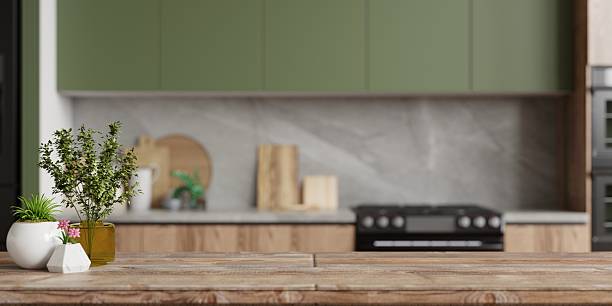 istock A minimalist and cozy home interior featuring a blank wooden table and a blurred modern kitchen in the background, creating a peaceful and inviting space- 3D rendering 2239849193