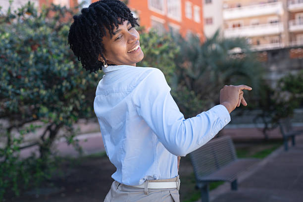 istock Happy young woman dancing in urban environment 2239852614