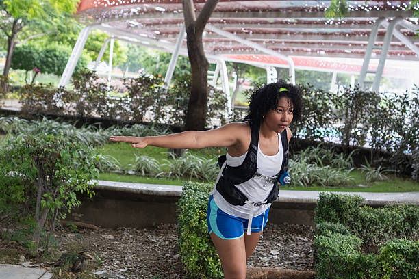 istock Woman preparing to run, stretching in park 2239853040