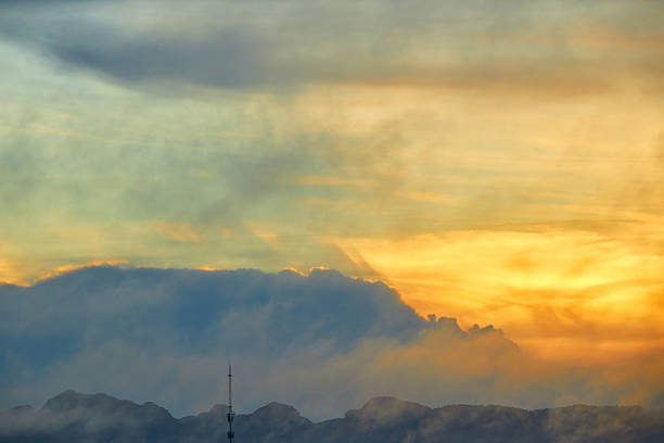 Fluffy clouds with warm light in morning over mountain in That Phanom, Nakhon Phanom, Thailand