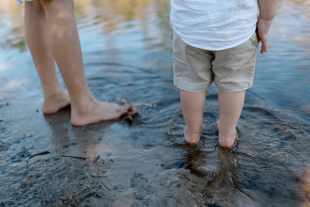 istock Young boys playing in a pond of water 2239853882