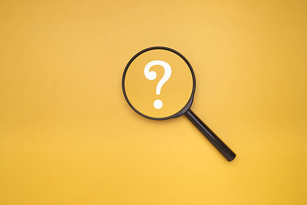 istock Magnifying glass with question mark symbol on yellow background. 2239856579