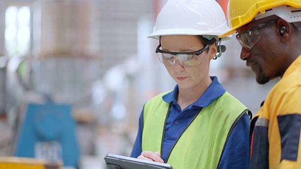 istock Female industrial manager and mechanical engineer supervise the production process, checking control panels and machinery functions. Their teamwork ensures efficiency, safety, and consistent output in the heavy manufacturing environment. 2239856764