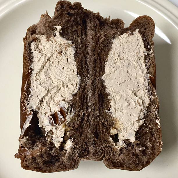 Soft and fluffy cream bread () filled with sweet, silky cream, offering a perfect bite of pillowy texture and rich, creamy indulgence in every delightful mouthful.