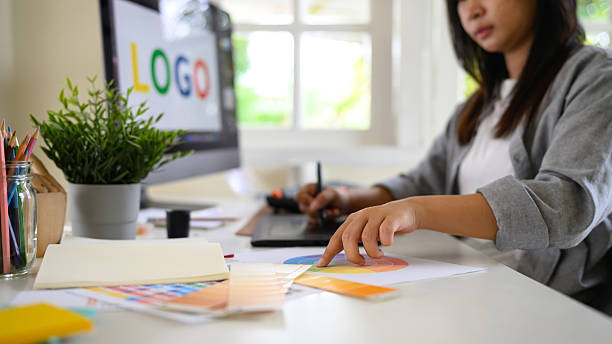 istock Designer hand pointing at color chart and drawing on tablet, focusing on branding and visual identity creation 2239858069