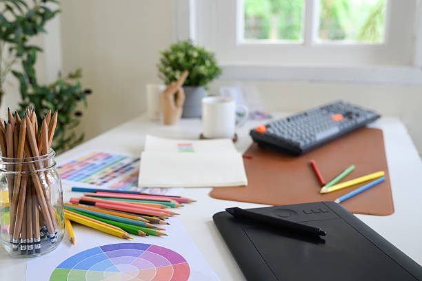 istock Modern creative workspace with colored pencils, color wheel chart, sketchbook, and digital drawing tablet 2239858104