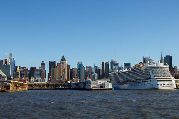 A Transatlantic boat and modern architecture skyscrapers skyline and One World Trade Center at the shore of Hudson river, financial district, Manhattan, New York City, United States