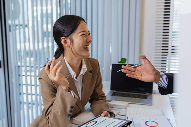 istock Business colleagues are engaged in a collaborative discussion, analyzing financial charts and reports on the wall and table. They exchange ideas, review strategies, and plan future goals. 2239859138