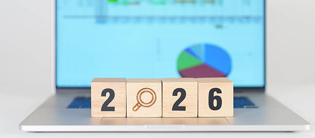 istock 2026 Year block with magnifying glass icon against laptop computer. SEO, Search Engine Optimization, hiring , Advertising, Idea, Strategy, marketing, Keyword, Content and New Year start concepts 2239859914