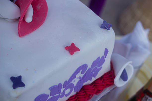 Festive cake, decorated with gold bows and a candle. Traditional birthday cake.