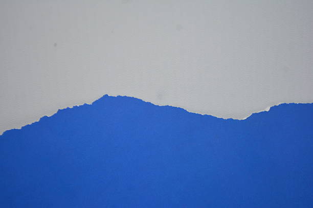 istock Ripped piece of blur blue paper, isolated element white background 2239863999