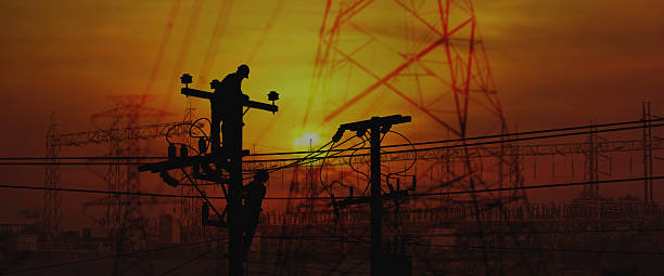 istock silhouette electric worker work late on electric pole connect the line from high voltage power supply and station 2239866290