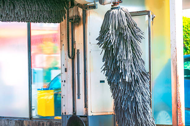 Close up shot of a clean blue brush washer at an automatic carwash station.