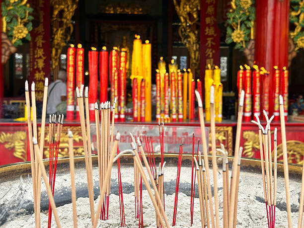 istock Burning incense praying sticks and candles in Buddhist Temple 2239869748