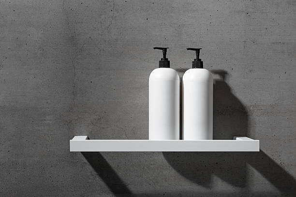 istock White bottles mock up on white shelf on gray concrete background, close up shampoo, conditioner. Aesthetic view beauty products in modern minimal bathroom neutral color. Side view, copy space 2239869867