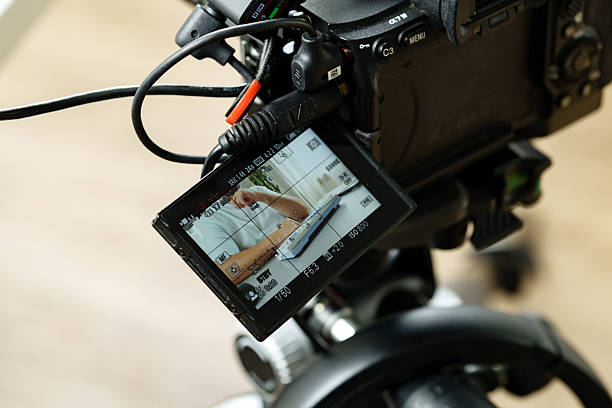 istock Camera setup focuses on close-up of a person demonstrating a practical skill in a studio setting 2239871418