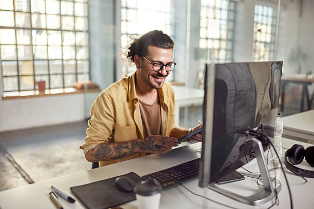 istock Happy businessman reading an e-mail on PC at corporate office. 2239873245