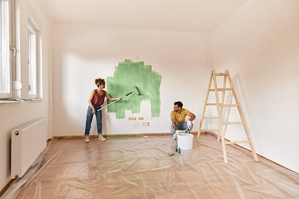 istock Happy couple having fun while painting their new apartment. 2239873738