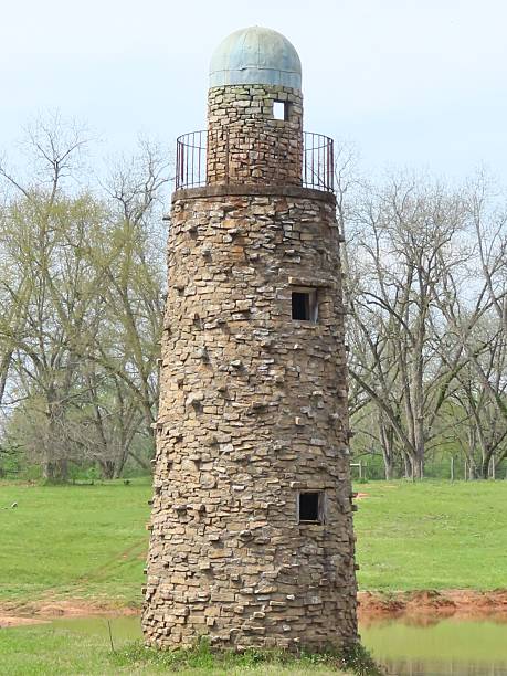 istock Rustic Stone Tower in Grassy Landscape 2239875223