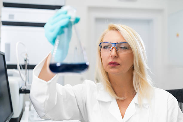 istock Female chemistry student observing solution in flask in teaching lab 2239875324